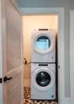 Modern, Whirlpool, stacked washer and dryer stocked with unscented laundry pods